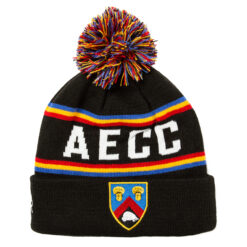 Rex Club | A colorful Toft CC Bobble Hat with a pom-pom on top, featuring black, red, blue, and yellow horizontal stripes, the letters "aecc" woven in white, and a shield patch with a lion crest at the fold. | Custom Caps | Custom Hats | Team Headwear | UK
