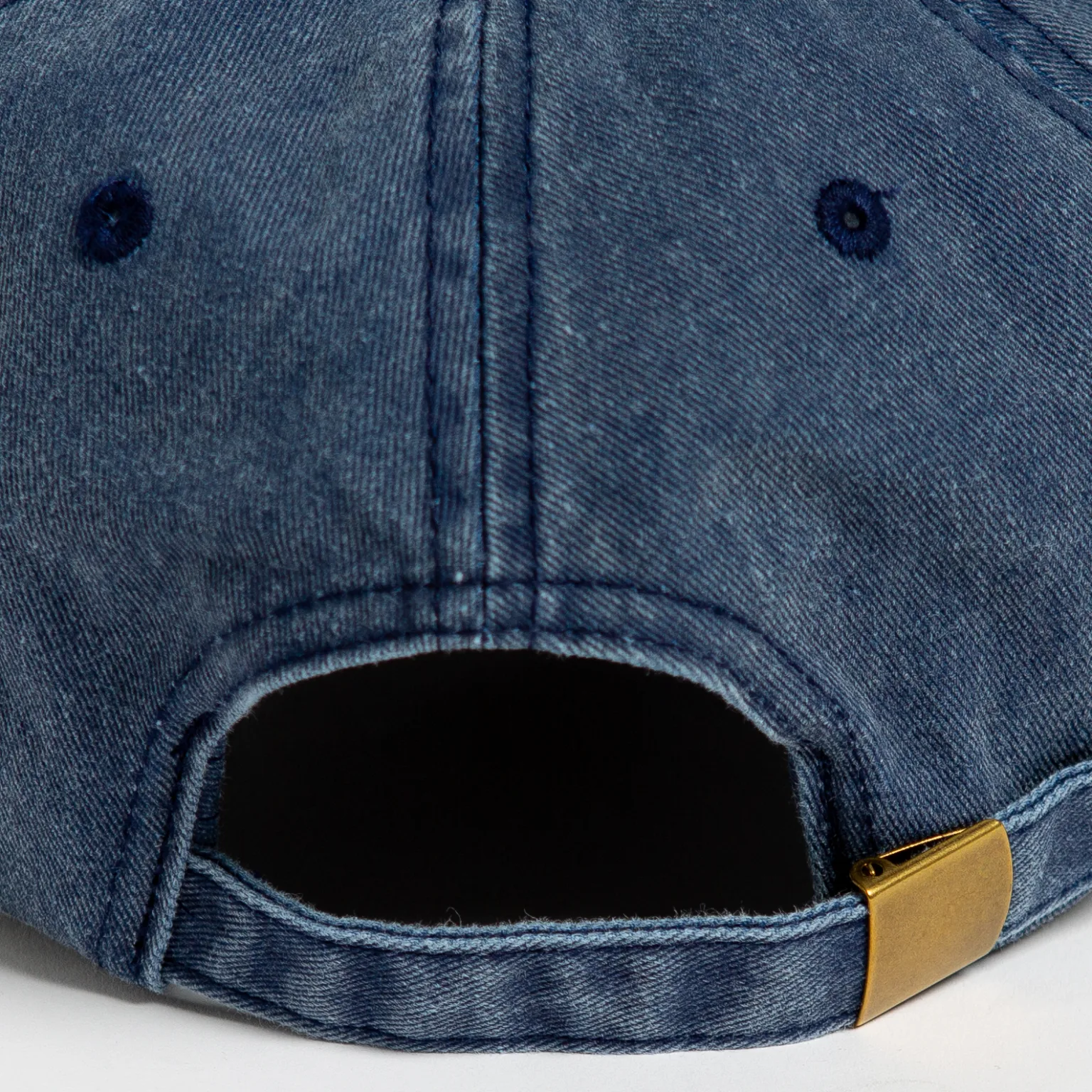 Rex Club | Close-up of the back of the Offseason 2025 blue denim baseball cap, featuring a fabric strap with a brass-colored buckle and stitched eyelets. | Custom Caps | Custom Hats | Team Headwear | UK