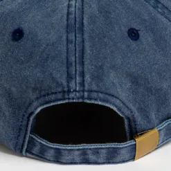 Rex Club | Close-up of the back of the Offseason 2025 blue denim baseball cap, featuring a fabric strap with a brass-colored buckle and stitched eyelets. | Custom Caps | Custom Hats | Team Headwear | UK
