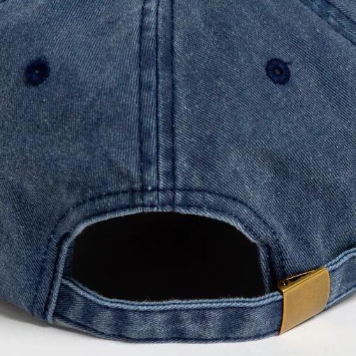 Rex Club | Close-up of the back of the Offseason 2025 blue denim baseball cap, featuring a fabric strap with a brass-colored buckle and stitched eyelets. | Custom Caps | Custom Hats | Team Headwear | UK