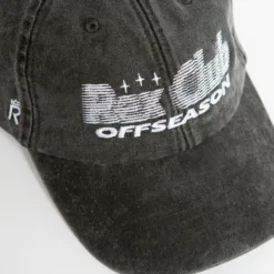 Rex Club | A close-up of the Offseason 2025 black baseball cap featuring white embroidered 