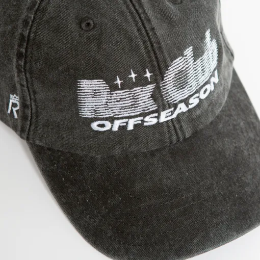 Rex Club | A close-up of the Offseason 2025 black baseball cap featuring white embroidered "Offseason" text with a stylized design of lines and stars on the front, plus a small "R" logo on the side. | Custom Caps | Custom Hats | Team Headwear | UK