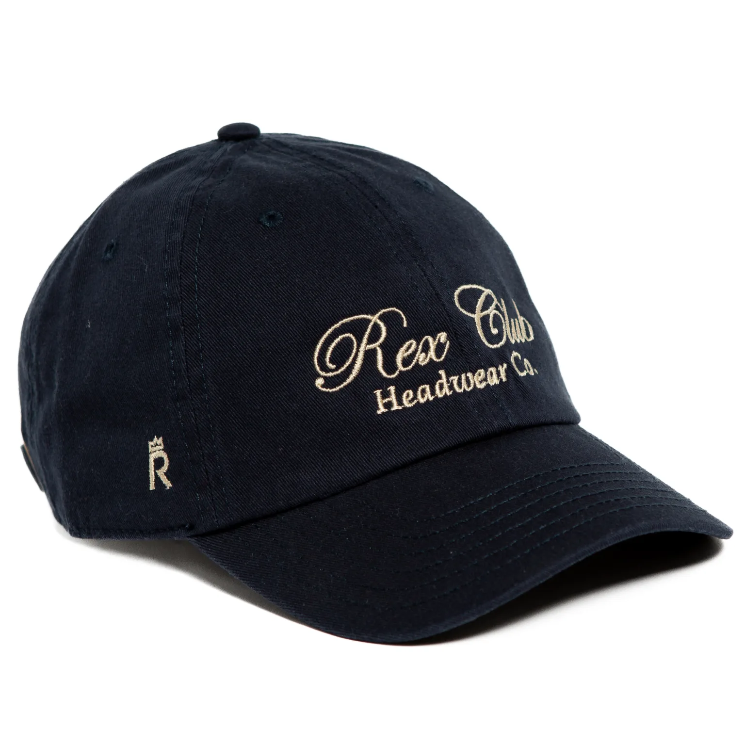 Rex Club | A black baseball cap with "Rex Club Headwear Co." embroidered in beige script on the front and a small beige "R" with a crown on the side. | Custom Caps | Custom Hats | Team Headwear | UK