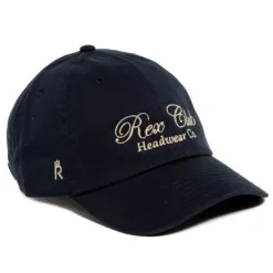 Rex Club | A sage green baseball cap with “Rex Club Headwear Co.” embroidered in beige on the front and a small crown logo on the side. The cap has a curved brim and visible stitching details. | Custom Caps | Custom Hats | Team Headwear | UK