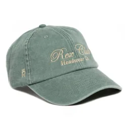 Rex Club | A sage green baseball cap with “Rex Club Headwear Co.” embroidered in beige on the front and a small crown logo on the side. The cap has a curved brim and visible stitching details. | Custom Caps | Custom Hats | Team Headwear | UK