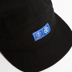 Rex Club | The Running Caps feature a black design with a blue and white rectangular patch displaying logos and 