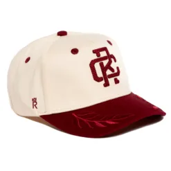 Rex Club | The Rex Club - TwoTone - Canvas Cap is a cream canvas baseball cap with a maroon brim and accents, featuring embroidered maroon initials on the front, a decorative leaf on the brim, and a small monogram on the side. | Custom Caps | Custom Hats | Team Headwear | UK