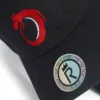 Rex Club | A close-up of the Norway Rugby Stretch black cap with a red dragon embroidered logo and a round sticker reading “FOR THE PLAYERS • FOR THE FANS” and “WWW.REXCLUB.CO.UK” around a stylized "R" and crown. | Custom Caps | Custom Hats | Team Headwear | UK