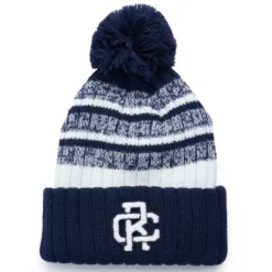 Rex Club | The Rex Club beanie features a navy cuff, white and blue patterned knit body, pom-pom top, and a chenille "RC" patch on the front. | Custom Caps | Custom Hats | Team Headwear | UK