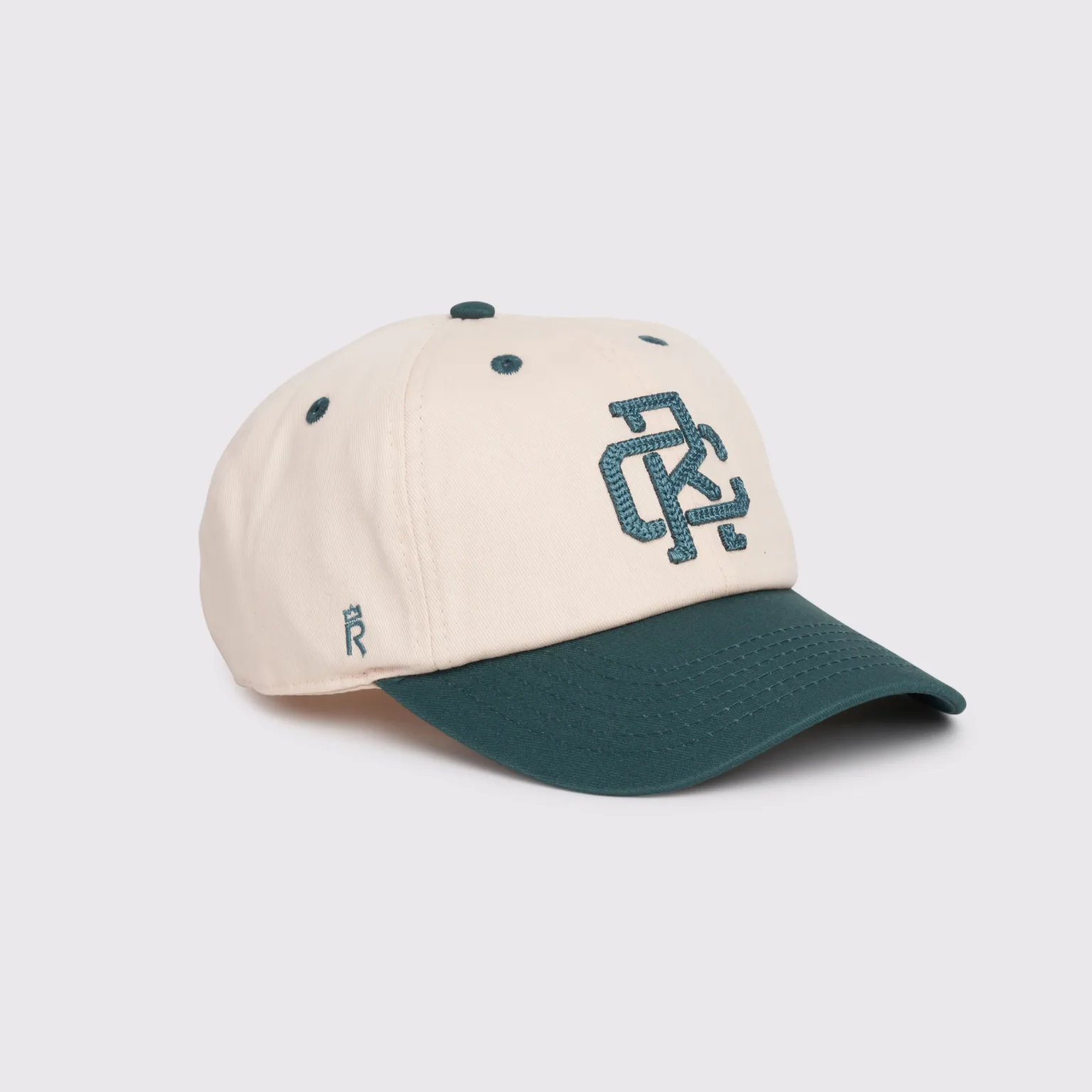 Rex Club | The RC - Victor - Two Tone (Copy) baseball cap features a cream crown, dark green brim, green button, and ventilation eyelets. The front sports a green interlocking "DC" logo, with a small green detail on the left side. | Custom Caps | Custom Hats | Team Headwear | UK