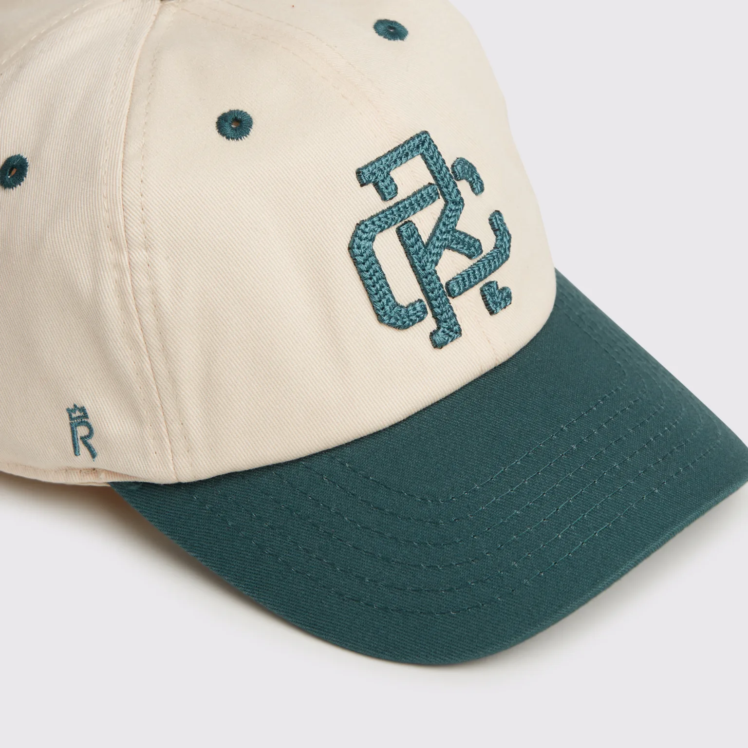 Rex Club | The RC - Two/Tone - SS26 Green is a beige baseball cap with a green visor, an embroidered green logo on the front, and a small crown symbol on the side. | Custom Caps | Custom Hats | Team Headwear | UK