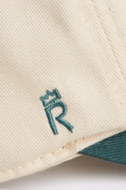 Rex Club | Close-up of RC - Two/Tone - SS26 Green: beige fabric features a green embroidered 