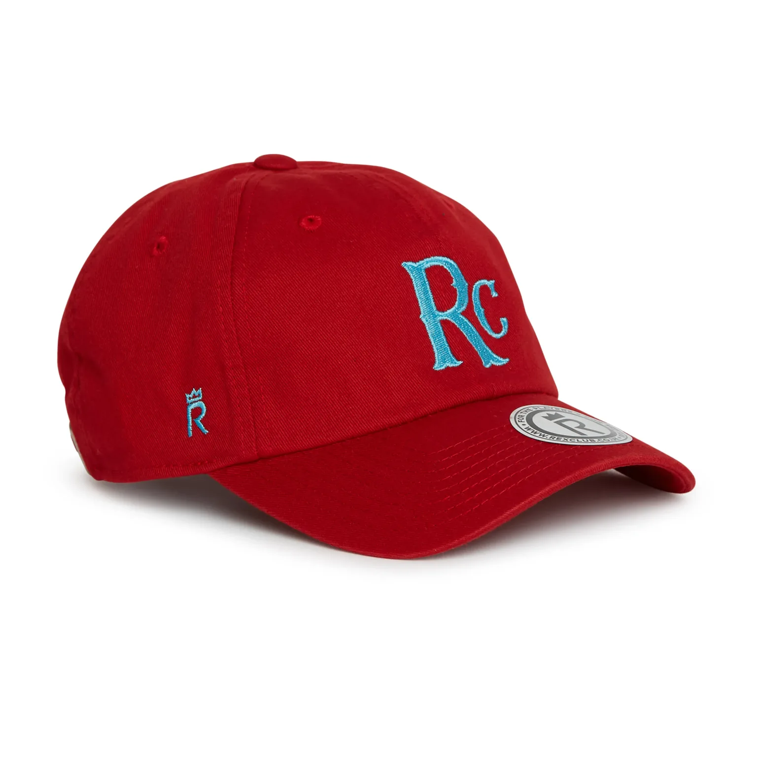 Rex Club | The RC 26 Slouch is a red baseball cap featuring light blue "RC" embroidery on the front and a small white patch on the peak, shown angled right against a plain white background. | Custom Caps | Custom Hats | Team Headwear | UK