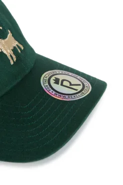 Rex Club | Close-up of a green Goat cap featuring an embroidered gold animal and a round sticker with the Rex Club logo, website, and repeated 