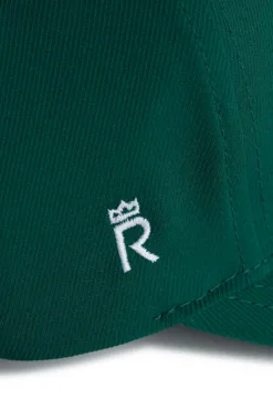 Rex Club | Close-up of the RC 26 Performance cap in green fabric, featuring a white embroidered 
