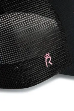 Rex Club | Close-up of the OFFSEASON 26 Trucker, a black mesh cap featuring a small pink embroidered 