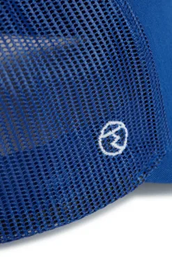 Close-up of blue mesh bag fabric with a white embroidered circular logo on it