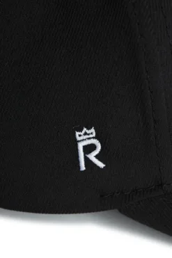 Rex Club | Close-up of RC 26 Performance's black fabric featuring a white embroidered 