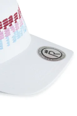 Rex Club | Close-up of a white OFFSEASON 26 baseball cap featuring pixelated red, pink, and blue lettering on the front and a round black and silver Rex Club logo sticker on the brim. | Custom Caps | Custom Hats | Team Headwear | UK