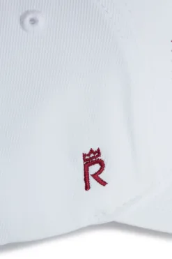 Rex Club | Close-up of the OFFSEASON 26 white fabric cap, featuring a small red embroidered letter 